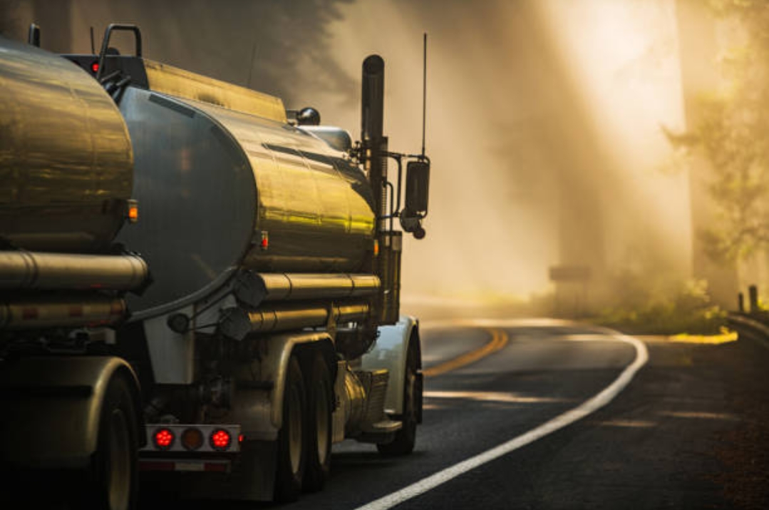 Bulk fuel tanker on the road at dawn